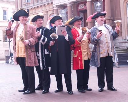 Town Criers form the English Toastmasters Association ringing the changes for new methods of communications.